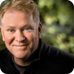 WeTransfer new page: Headshot of Moenning, smiling with blue eyes. Professional portrait for WeTransfer.